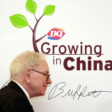 Billionaire investor and Berkshire Hathaway CEO Warren Buffett signs an autograph at the inauguration of a Dairy Queen store in Beijing in September 2010. Photo: Xinhua
