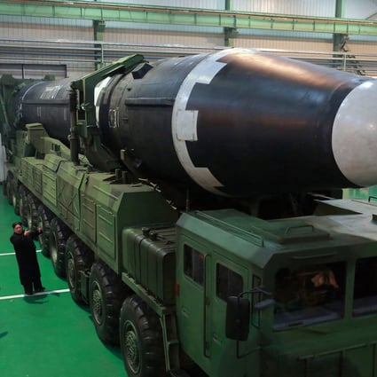 North Korean leader Kim Jong-un standing next to a Hwasong-15 long-range missile. Photo: AP