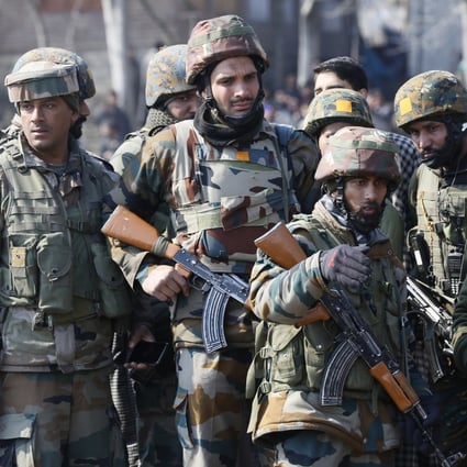 Indian army soldiers near the wreckage of an Indian helicopter. Photo: AP