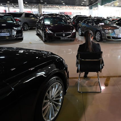 A sales representative waits for customers in a luxury car showroom in Beijing on January 22, 2019. Photo: Agence France-Presse