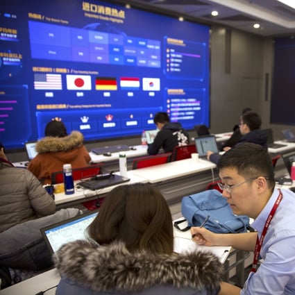 Workers talk as displays show sales data at the command centre at the headquarters of e-commerce retailer JD.com in Beijing on November 11, 2018. Photo: AP