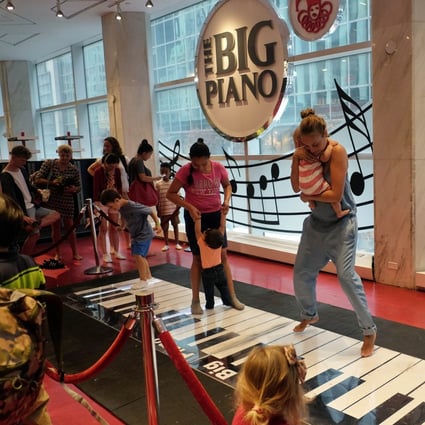 Customers experiencing the dance-on floor piano at the New York outlet of FAO Schwarz on its last day of operation on July 15, 2015. Former owner Toys’R’Us decided to close the Fifth Avenue store two months earlier, citing high and rising costs of running the 45,000-square-foot retail space. Photo: AFP