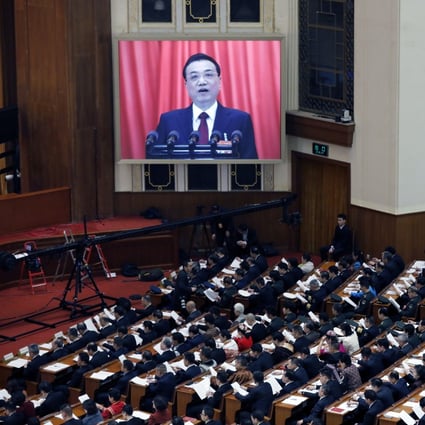 Chinese Premier Li Keqiang appears on a screen as he speaks during the opening of the second session of the 13th National People’s Congress outside the Great Hall of the People in Beijing. Photo: EPA