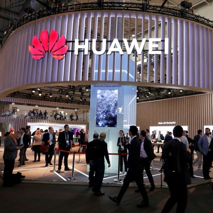 Visitors walk next to Huawei Technologies’ booth at industry trade show MWC Barcelona in Spain on February 27, 2019. Photo: Reuters