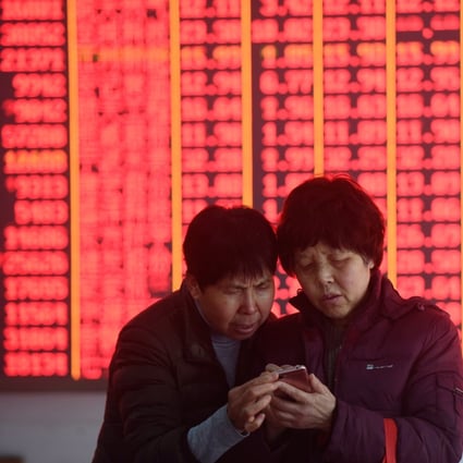China stocks entered a bull market last week. Here, investors look at share prices in Hangzhou on March 4, 2019. In China, red signals gains. Photo: Xinhua