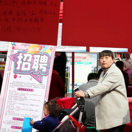 Job seekers look at the job advertisements at a job fair for women on the International Women's Day in Huaibei, Anhui province, on Friday. Photo: Reuters