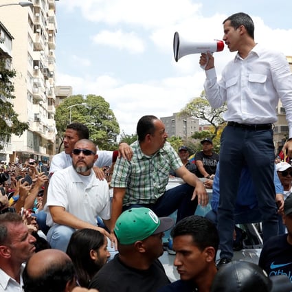 Venezuelan opposition leader Juan Guaido, who many nations have recognised as the country's rightful interim ruler, speaking at a rally against Venezuelan President Nicolas Maduro's government in Caracas on Saturday. Photo: Reuters