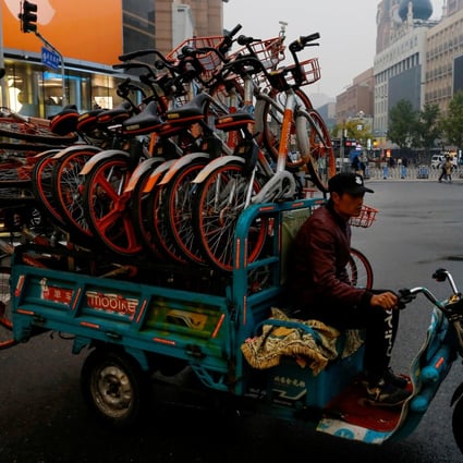 A man rides a tricycle transporting Mobike shared bikes near Wangfujing Street in Beijing on October 15, 2018. Photo: Reuters