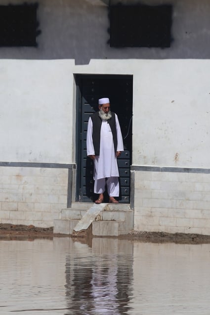 A man looks out of his home at a flooded street in Khyber Pakhtunkhwa province on April 16 as Pakistan floods again. The world is drowning in information amid challenges from climate change, geopolitical tensions, outright war, artificial intelligence and more. Photo: EPA-EFE