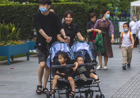  A couple push children in a stroller in Shanghai on June 1. Chinese mothers gave birth to 12 million babies last year, down from 14.65 million in 2019, marking an 18 per cent decline year on year. Photo: EPA-EFE