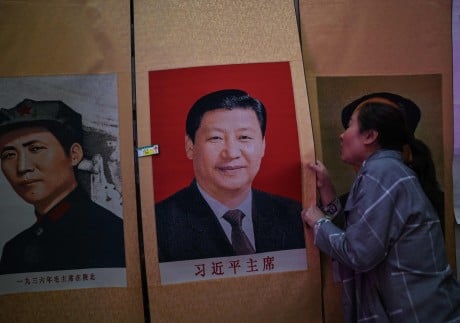 “Serve the people” became the party’s unofficial motto during the Mao Zedong (left) era. President Xi Jinping has his own set of slogans. Photo: AFP
