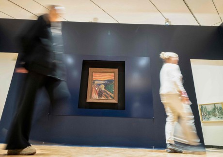 People pass by the painting “The Scream” by Norwegian artist Edvard Munch in the new Munch Museum in Oslo. Three versions of the  famous work are on show. Photo: Terje Pedersen/NTB/AFP