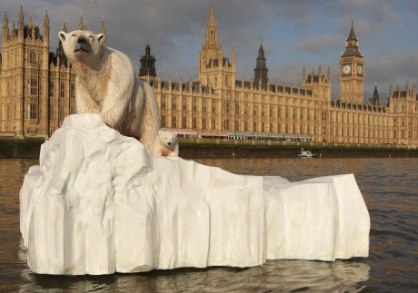 A five-metre (16 ft) high sculpture of a polar bear and cub, afloat on a small iceberg, passes in front of the Houses of Parliament in London to alert lawmakers to the dangers of climate change. Photo: Getty Images