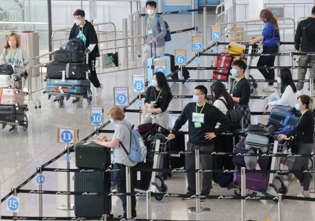 Passengers line up at a quarantine processing area  in the arrivals hall at Hong Kong International Airport on Wednesday.  Photo: Jelly Tse