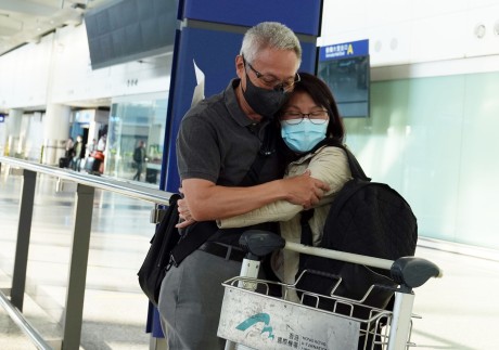 A traveller hugs a loved one after being among the first in Hong Kong to arrive without having to serve quarantine. Photo: Sam Tsang