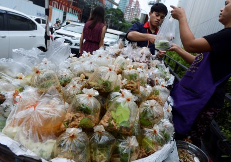 A vendor sells food packed in plastic bags in Bangkok in June 2018. Photo: AFP