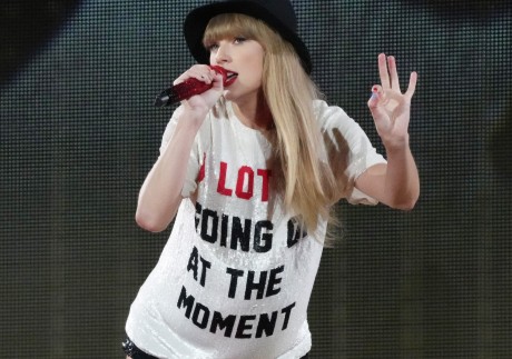 Taylor Swift performs onstage during her Eras tour in 2023 in California. Graphic T-shirts like the one she is wearing here can often pack a political or social punch even when they are not intended to by their designers. Photo: Getty Images