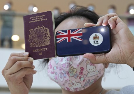 A protester in Hong Kong holds a British National (Overseas) passport during a protest against China’s national security legislation for the city. Photo: AP