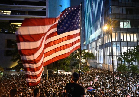 An American flag is waved during an October 2019 rally in Hong Kong. Photo: AFP