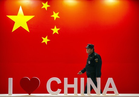 A security officer walks past a display at the PT Expo in Beijing last October. Photo: AP