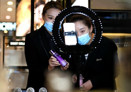 Make-up saleswomen use live-streaming marketing to boost sales during China’s annual November online shopping spree. Many consumers bought products they could not afford on credit. Photo: Xinhua