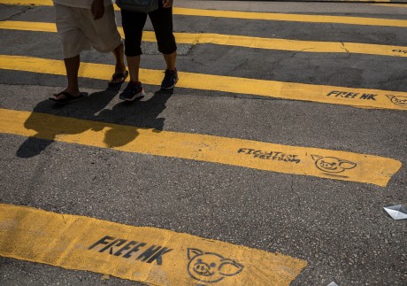 Pedestrians walk past graffiti on a pedestrian crossing reading “Free HK” and “Fight For Freedom” in Causeway Bay, Hong Kong, on October 2, 2019. Photo: Bloomberg
