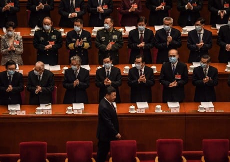 Delegates applaud as China's President Xi Jinping arrives for the opening session of the National People's Congress (NPC) at the Great Hall of the People in Beijing on March 5, 2021. Photo: AFP