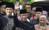 Malaysia's new Prime Minister Muhyiddin Yassin waving outside his residence before his inauguration on Sunday. Photo: Handout