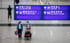 Passengers walk through the arrival hall at Hong Kong International Airport. Photo: EPA-EFE
