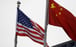 Chinese and American flags flutter outside the building of a US company in Beijing. Photo: Reuters