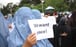 Afghan people hold placards during a protest to condemn violence in Herat, Afghanistan, on May 2. Photo: EPA-EFE