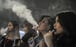 Women smoke electronic cigarettes at the VapeFair in Kuala Lumpur, Malaysia. Photo: AFP