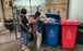 A child puts plastic delivery bags into a recycling bin. Photo: EPA