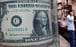 An image of a US dollar bill at a currency exchange bureau in Cairo. The dollar is losing its lustre against gold, silver and other key currencies. Photo: Reuters