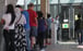 People wait outside the temporary testing facility at the Harbour Road Sports Centre in Wan Chai. Photo: Xiaomei Chen