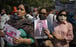 A woman holds a vandalised photograph of Chinese President Xi Jinping at a protest near the Chinese embassy in New Delhi, India. Photo: AP