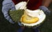 A Malaysian durian seller shows off the golden yellow fruit. Photo: EPA