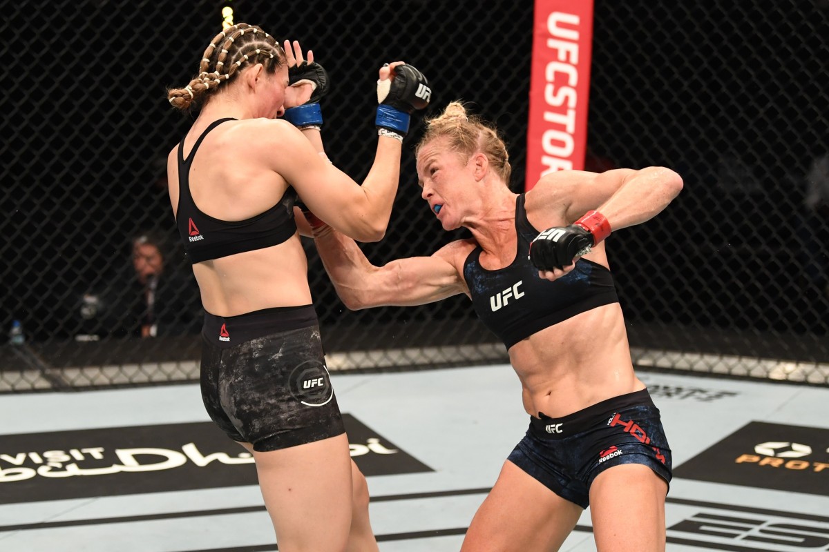 Holly Holm punches Irene Aldana in their women’s bantamweight bout during t...